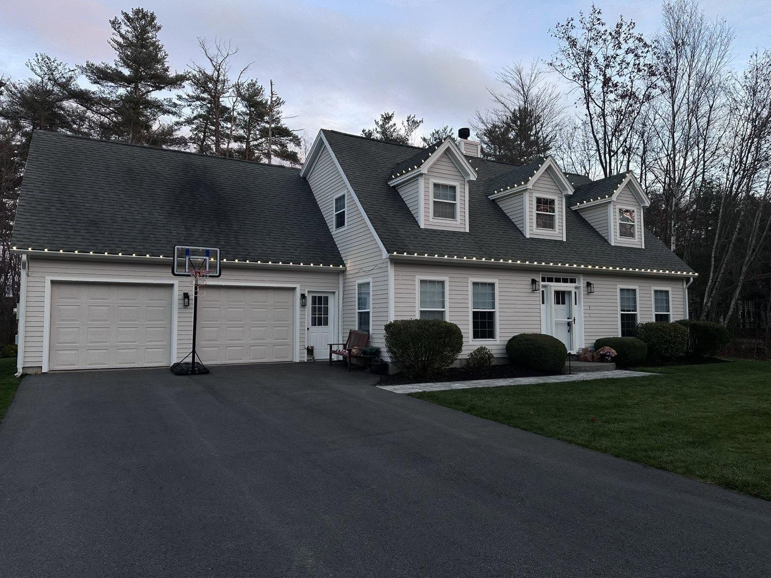 Daytime close view of evenly spaced C9 bulbs on a clean white roofline